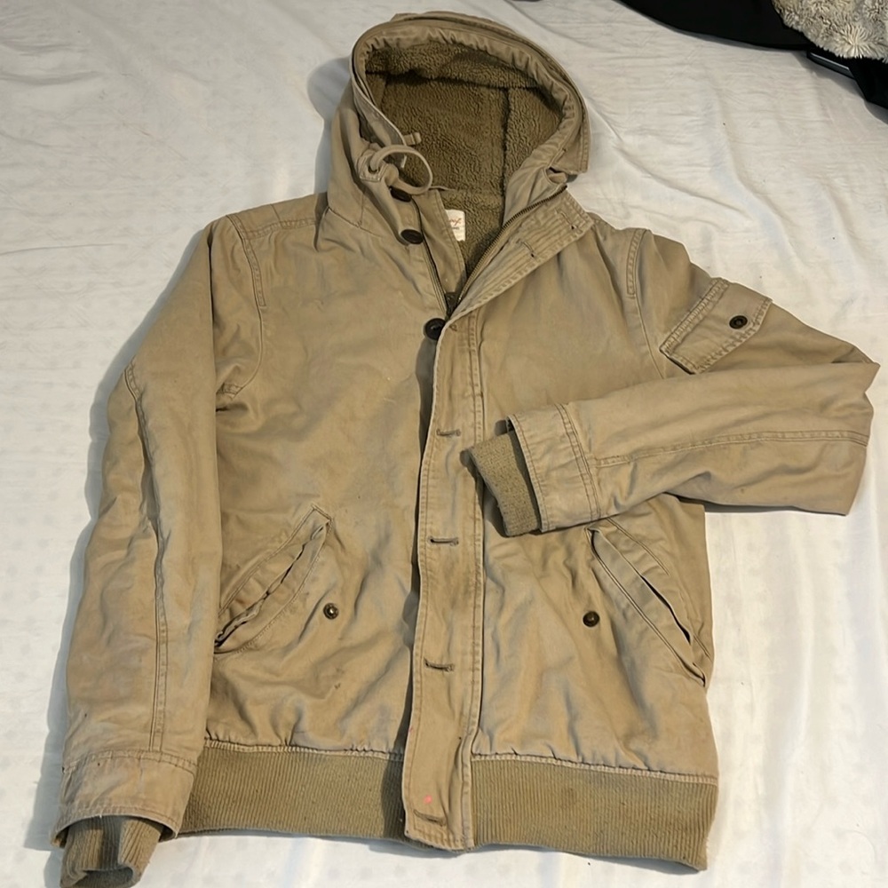 A vintage coat with a wooly inside.